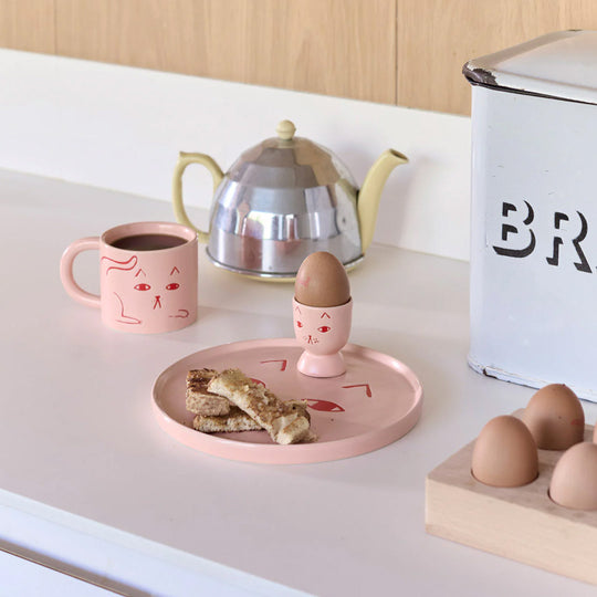 Donna Wilson Stoneware Egg Cup in candy pink stoneware featuring a cute (if grumpy) cat illustration, Donna Wilson style. A feline fine egg cup for your dippy eggs and soldiers.