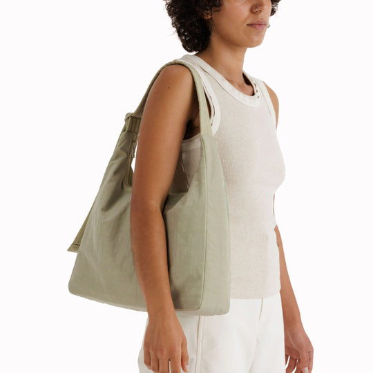Practical shoulder bag designed for daily use and urban mobility. Crafted from recycled heavyweight nylon with a recycled ripstop lining