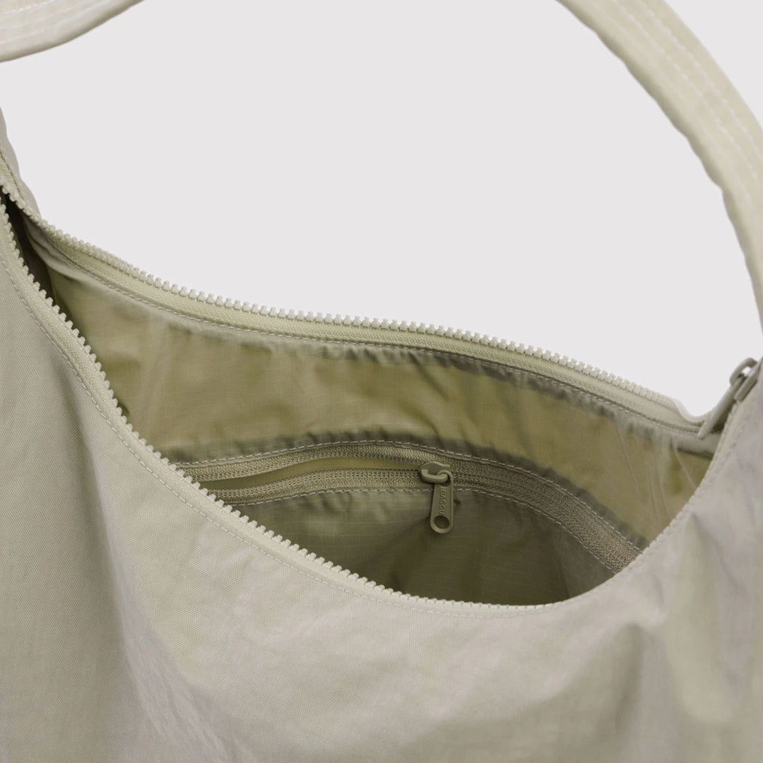 Practical shoulder bag designed for daily use and urban mobility. Crafted from recycled heavyweight nylon with a recycled ripstop lining