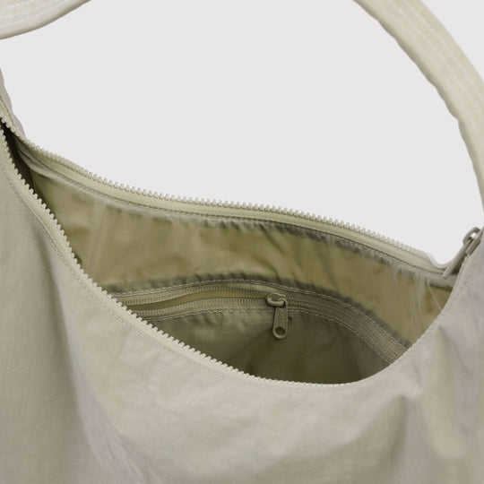 Practical shoulder bag designed for daily use and urban mobility. Crafted from recycled heavyweight nylon with a recycled ripstop lining