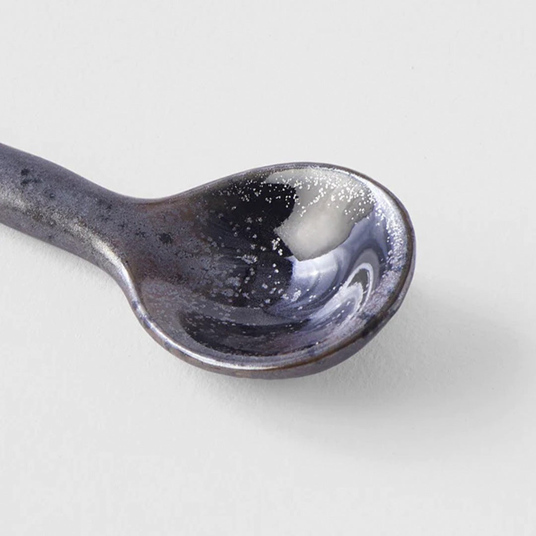 A small earthenware spoon with black 'speckle' glaze. 12cm in length, made of 'Minoyaki' porcelain, fired at a high temperature and hand finished in Gifu prefecture, Japan.