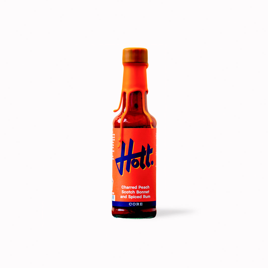This unique sauce boasts a distinctive flavour profile, combining the sweetness of charred peaches with the warmth of Scotch bonnets and the aromatic complexity of spiced rum, featuring notes of ginger, cinnamon, cloves, and vanilla.