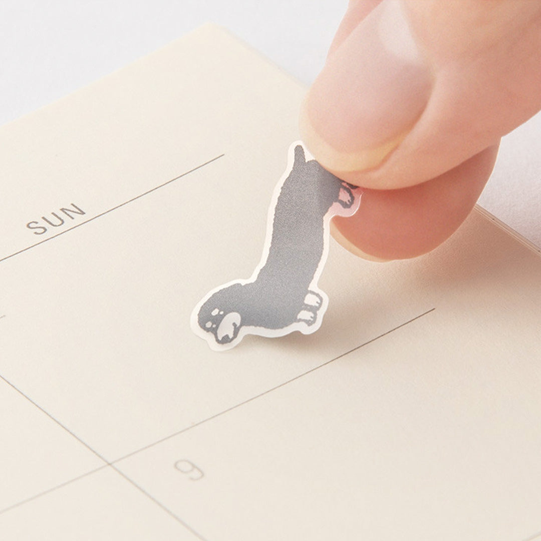 Add some personality to your journalling with Midori's chat dog stickers. The mono coloured hand drawn designs have a low tack sticky adhesive back meaning that they are reusable and are printed on a hardwearing translucent acrylic paper to look like they are printed on the page.