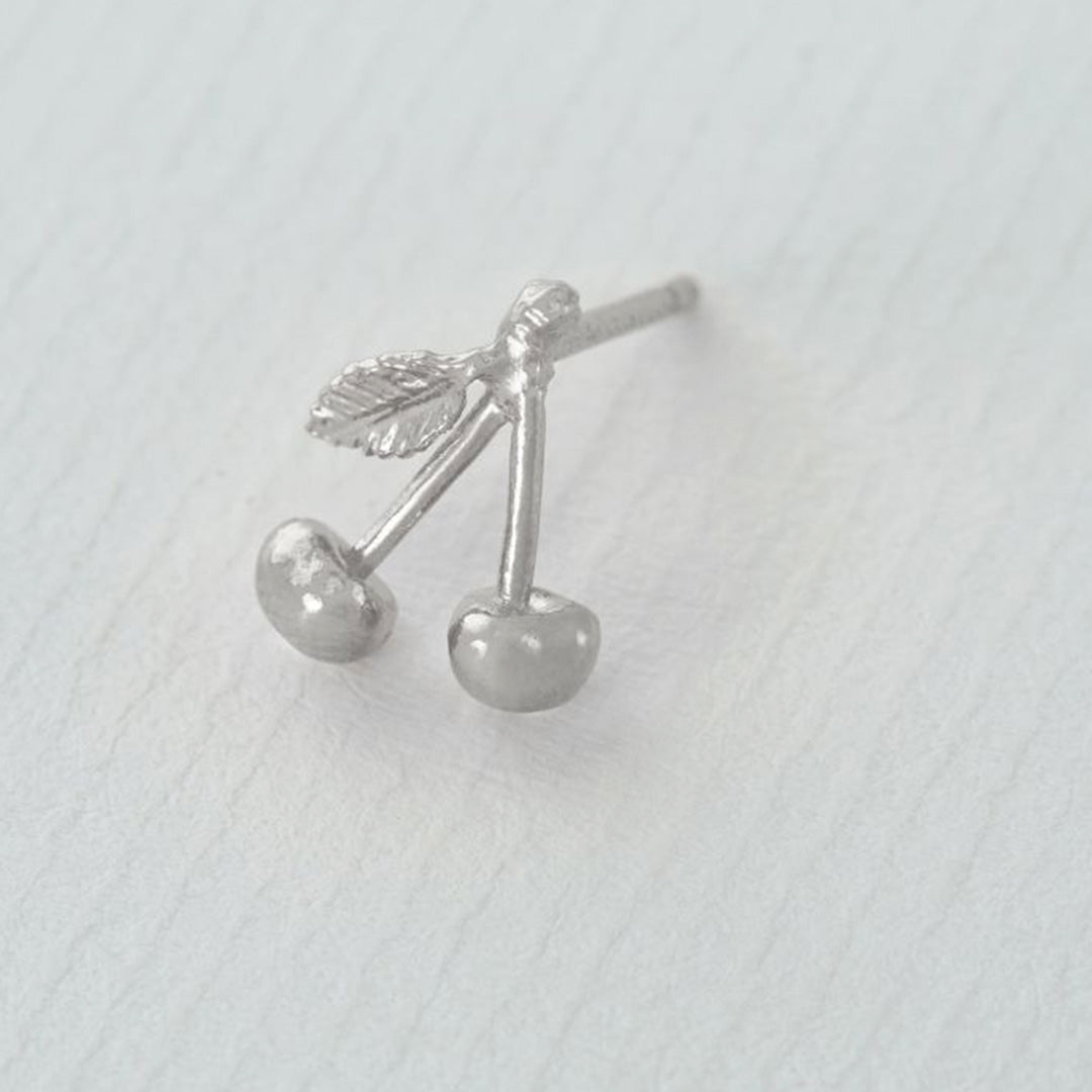 Detail of Silver Fruity Cherry Single stud earring from Alex Monroe's 'La Dolce Vita' collection. Inspired by long warm days in Italy, and the scents of summer fruits.