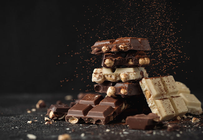 tower stack of various different chocolate bars