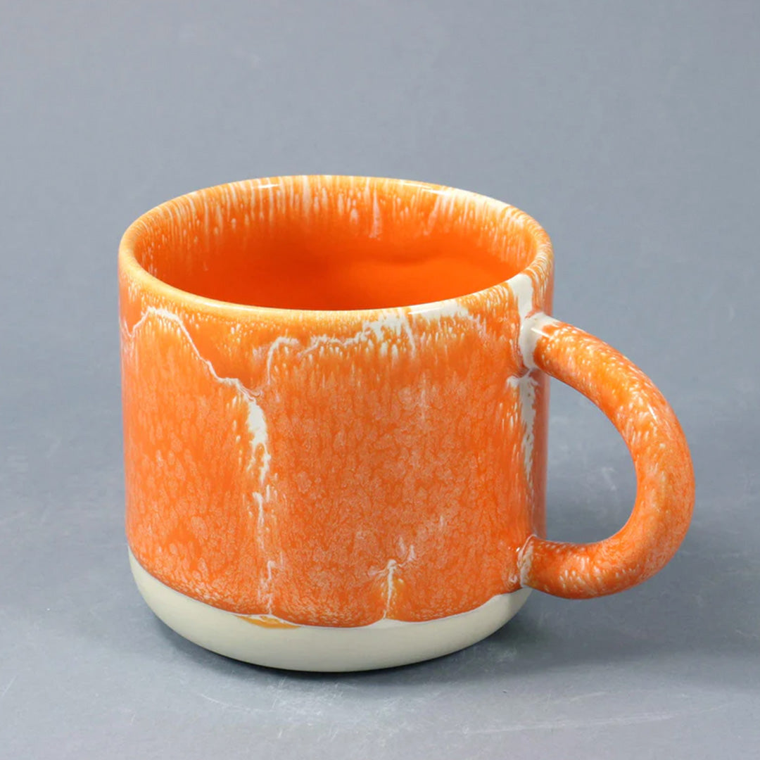A bright orange, heavy glazed, Japanese inspired ceramic mug from Studio Arhoj. The Chug Mug features their trademark thick, hand poured coloured glaze which means that each mug is unique.