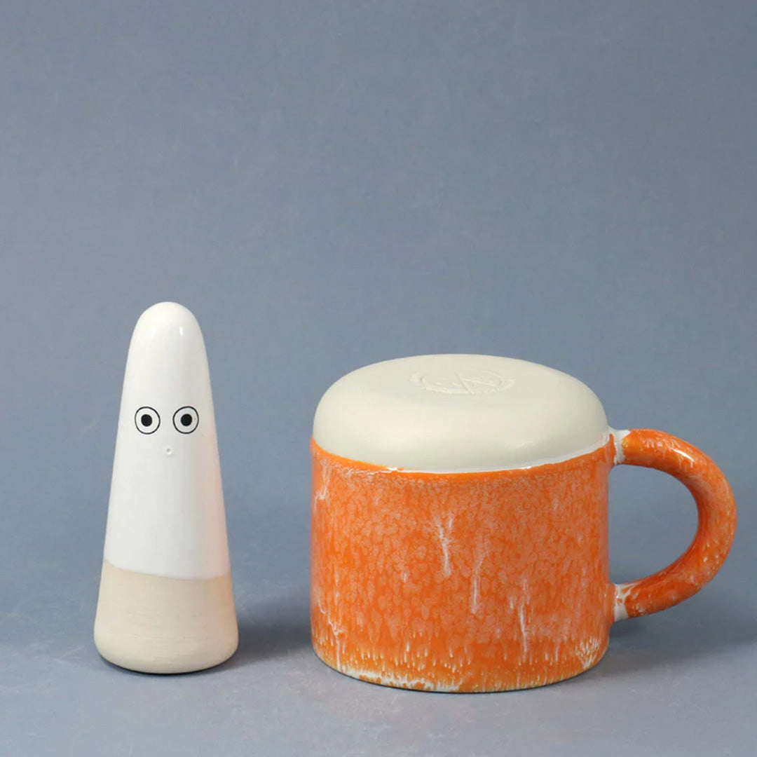A bright orange, heavy glazed, Japanese inspired ceramic mug from Studio Arhoj. The Chug Mug features their trademark thick, hand poured coloured glaze which means that each mug is unique.