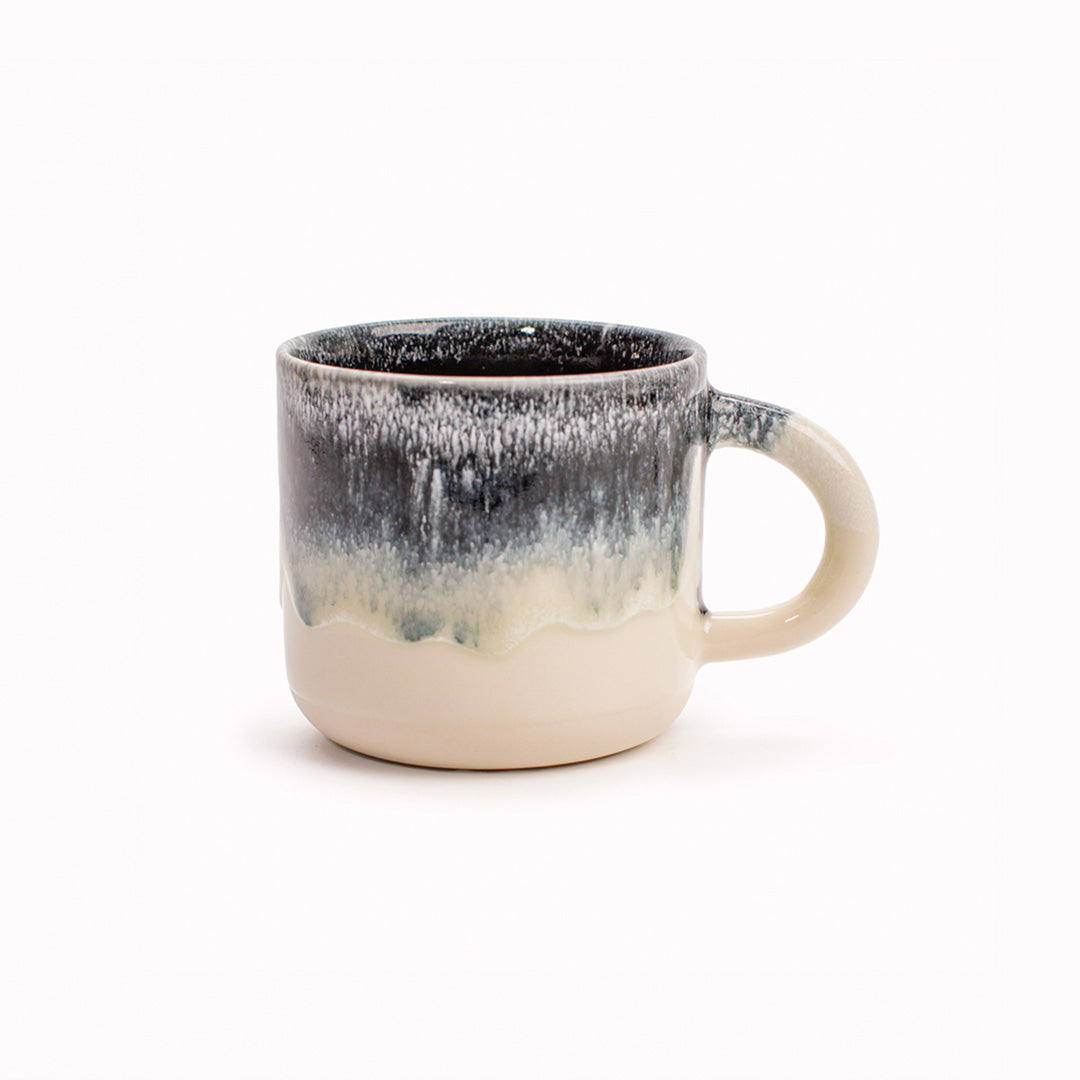 A monochrome black and white, heavy glazed, Japanese inspired ceramic mug from Studio Arhoj. The Chug Mug features their trademark thick, hand poured coloured glaze which means that each mug is unique.
