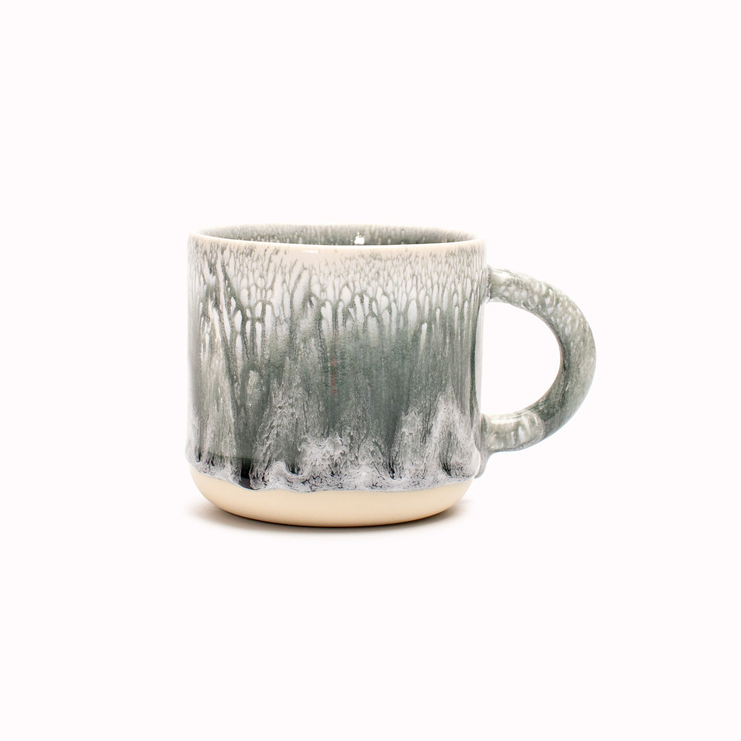 A moody grey green, heavy glazed, Japanese inspired ceramic mug from Studio Arhoj. The Chug Mug features their trademark thick, hand poured coloured glaze which means that each mug is unique.