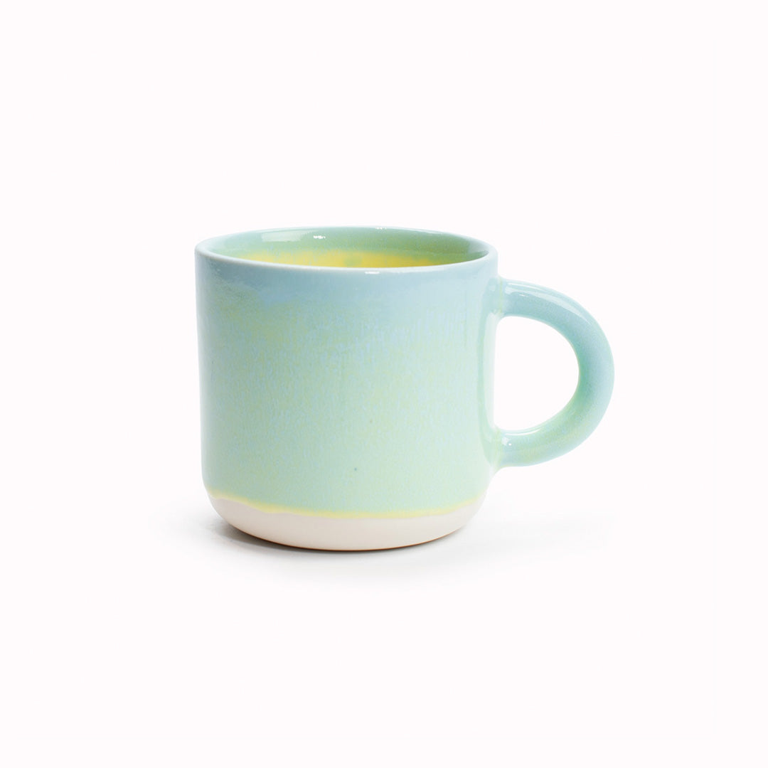 The Yellow Snapper is a distinctive pastel green outside with a warm yellow inside, heavy glazed, Japanese inspired ceramic mug from Studio Arhoj. The Chug Mug features their trademark thick, hand poured coloured glaze which means that each mug is unique.