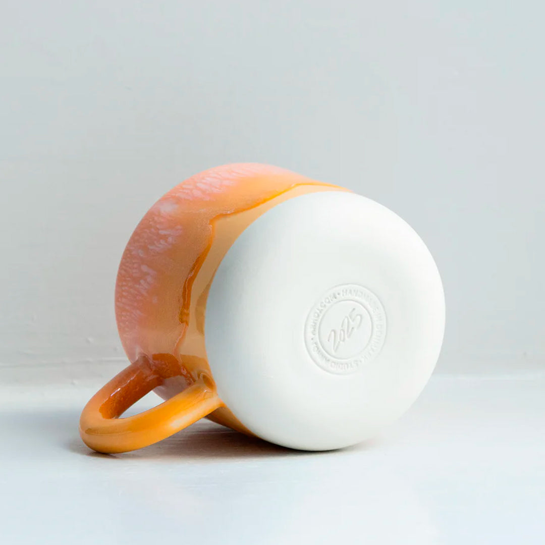 Mandarin is a heavily glazed vibrant orange, Japanese inspired ceramic mug from Studio Arhoj. The Chug Mug features their trademark thick, hand poured coloured glaze which means that each mug is unique.