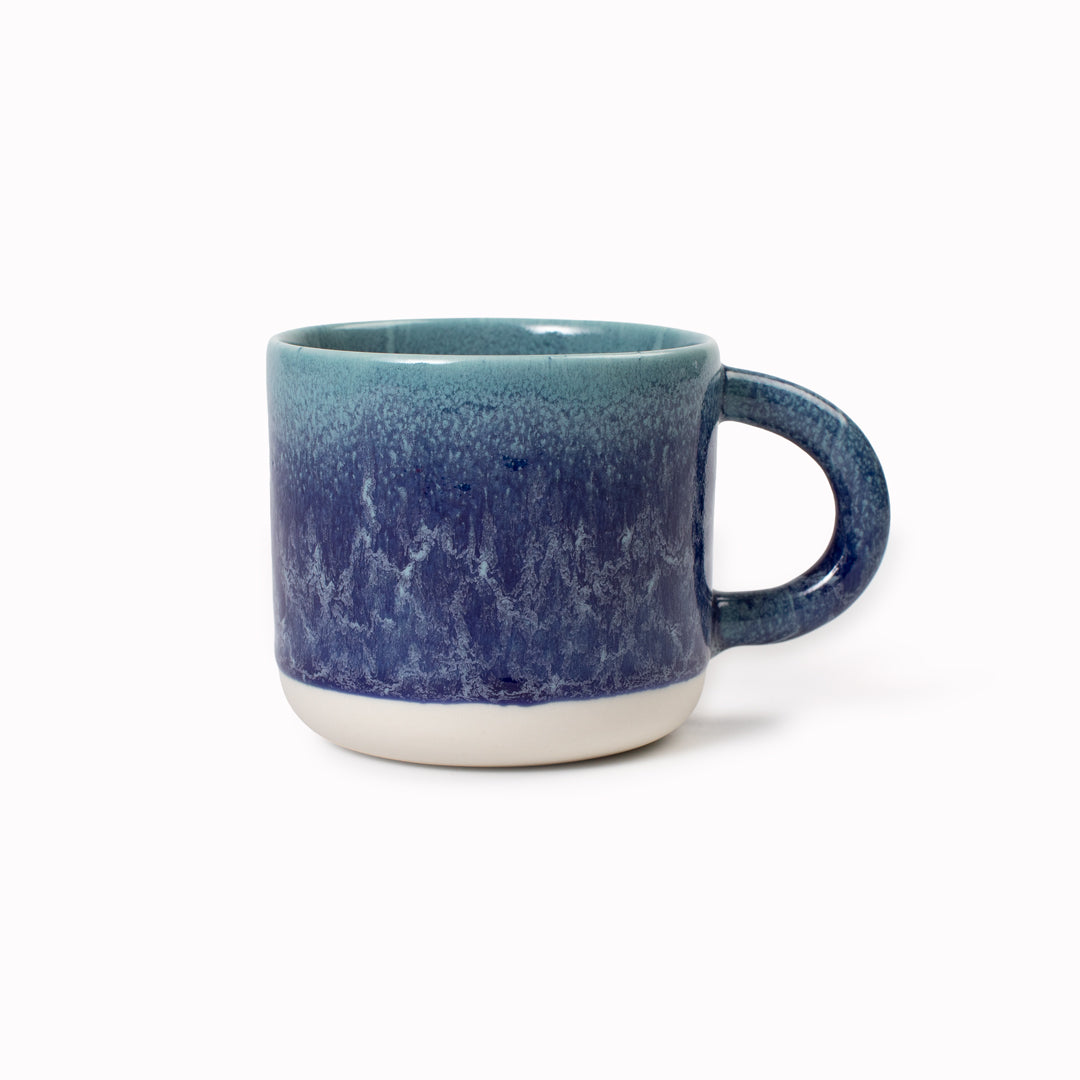 Mariana is a blue hued heavy glazed, Japanese inspired ceramic mug from Studio Arhoj. The Chug Mug features their trademark thick, hand poured coloured glaze which means that each mug is unique.