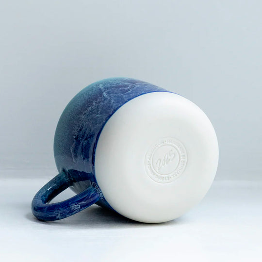 Mariana is a blue hued heavy glazed, Japanese inspired ceramic mug from Studio Arhoj. The Chug Mug features their trademark thick, hand poured coloured glaze which means that each mug is unique.