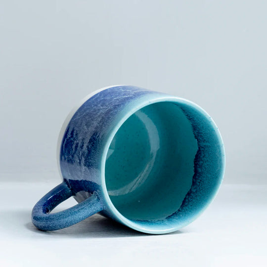 Mariana is a blue hued heavy glazed, Japanese inspired ceramic mug from Studio Arhoj. The Chug Mug features their trademark thick, hand poured coloured glaze which means that each mug is unique.