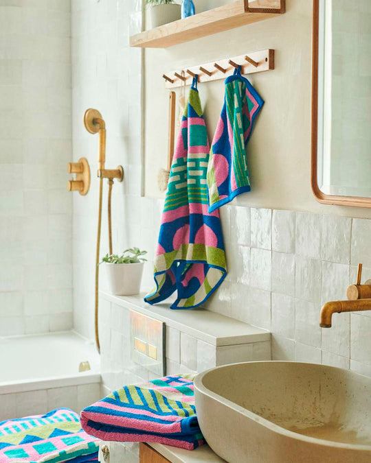 The Circus Collection of Towels from Donna Wilson is a vibrant colour filled graphic illustration inspired by the magic of the big top.
