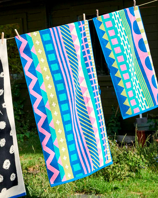 The Circus Collection of Towels from Donna Wilson is a vibrant colour filled graphic illustration inspired by the magic of the big top.