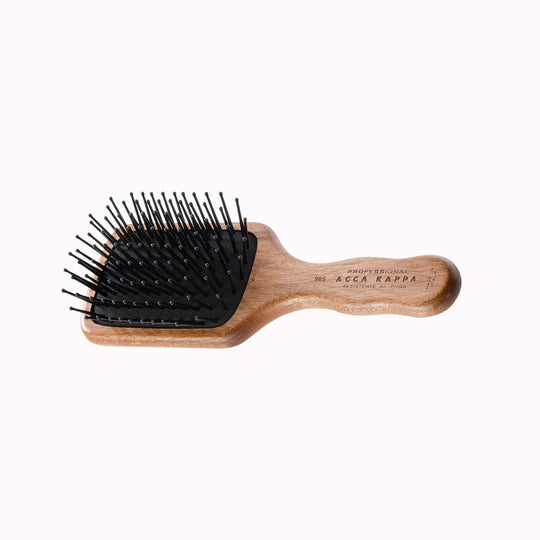 The Classic Paddle Brush with Pom Pins from Acca Kappa is a premium grooming tool, designed to offer a luxurious experience in hair care