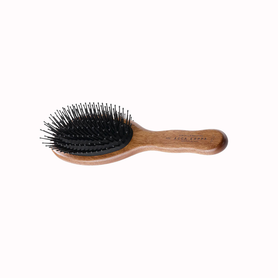 The Classic Oval Brush with Pom Pins from Acca Kappa is a premium grooming tool, designed to offer a luxurious experience in hair care