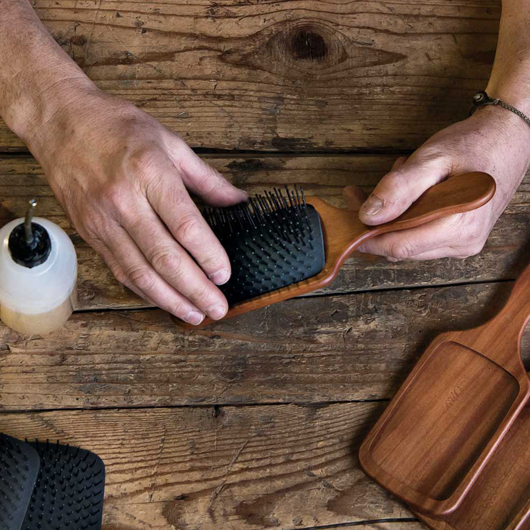 The Classic Paddle Brush with Pom Pins from Acca Kappa is a premium grooming tool, designed to offer a luxurious experience in hair care