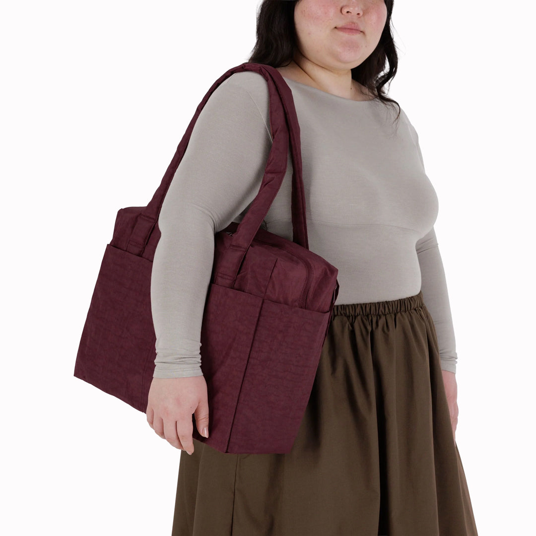The small 'Cloud' Carry-On from Baggu is constructed from durable heavyweight nylon. Its versatile design has been optimised for air travel where its size allows it to fit under an aeroplane seat.