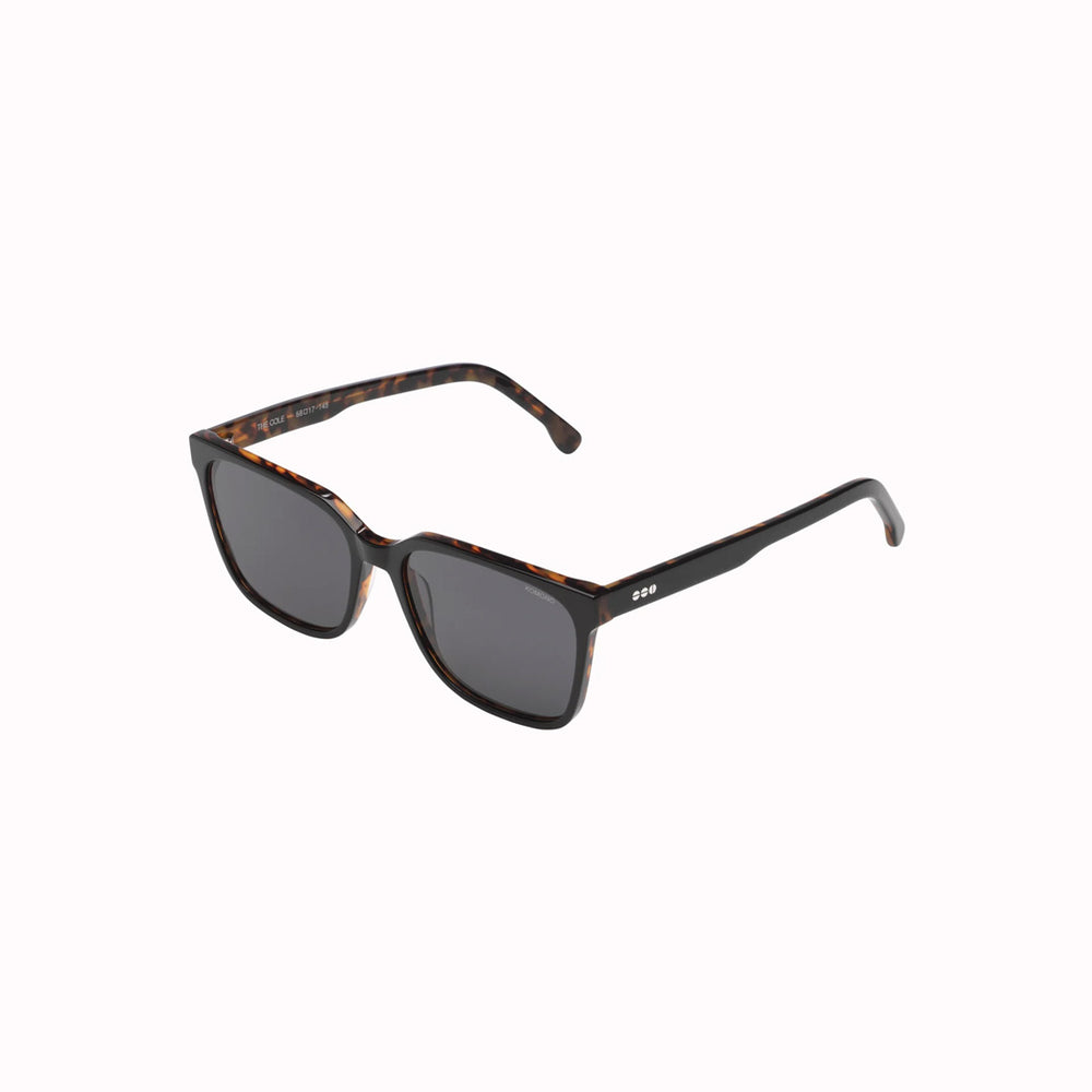 Sideways View, Strong lines, elegant and fine. The Cole makes sure to bring out your best features with its fine acetate frame. The Cole Black Tortoise sunglasses feature a black frame edged with tortoiseshell in Eco Acetate and solid smoke lenses. Subtly striking.