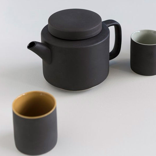Collection with cups, Large stoneware teapot from Dutch company Kinta who produce contemporary ceramics and homeware. The large teapot is black, with a soft matt exterior finish. Its design is influenced  by ceramic trends of the 1960s, but with a pleasing modern and neutral colour palette.