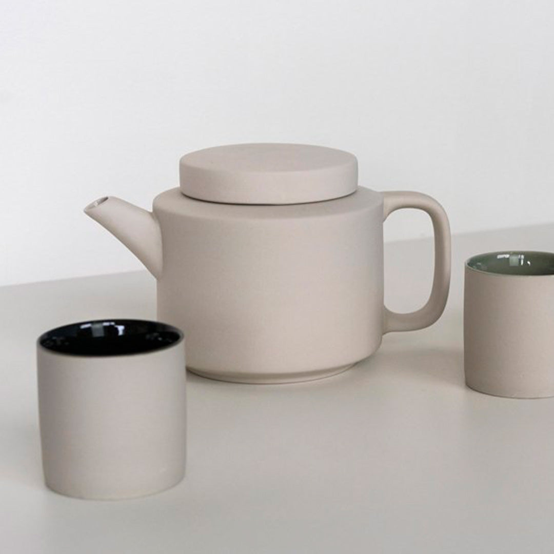 Collection with Cups of the extra large stoneware teapot from Dutch company Kinta who produce contemporary ceramics and homeware. The extra large teapot is clay grey in colour, with a soft matt exterior finish. Its design is influenced  by ceramic trends of the 1960s, but with a pleasing modern and neutral colour palette. 