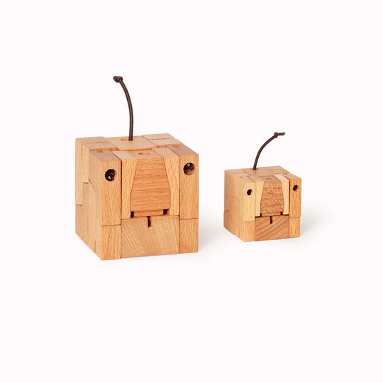 Folded up - Cubebot is a fun wooden toy dog that folds out of a perfect cube shape.  Part puzzle, part posable toy they are inspired by Japanese Shinto Kumi-ki puzzles and can be positioned to hold dozens of poses. 