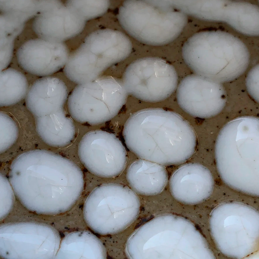 Danish Designers Studio Arhoj are renowned for their unique and colourful ceramics and the Curdle Spring Bowl with textured white glaze is no exception - sample glaze