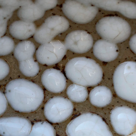 Danish Designers Studio Arhoj are renowned for their unique and colourful ceramics and the Curdle Spring Bowl with textured white glaze is no exception - sample glaze