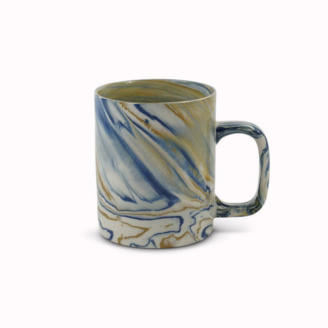 Blue and mustard marbled gloss glaze mug from Dutch company Kinta, who produce contemporary ceramics and homeware. The stoneware mug has a striking marbled effect glaze with blue and mustard colouring. The glaze on the outside and on the interior is glossy and it holds 350ml