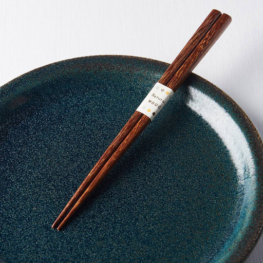 Dark Wood Chopsticks from Made in Japan. Chopsticks have been used as kitchen and eating utensils in East Asia for over two million years. These chopsticks are a natural wood chopstick they feel great in the hand and have a lovely taper to their edge. Detail View