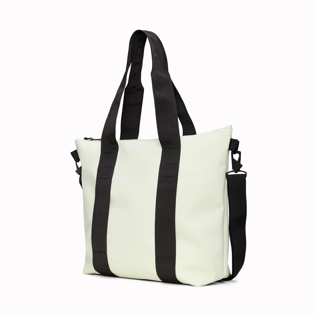 Angled - Rains' Tote Bag Mini W3 in new season fashion colour Daze is a waterproof tote bag and a great companion for shopping trips as well as commuting to the office.