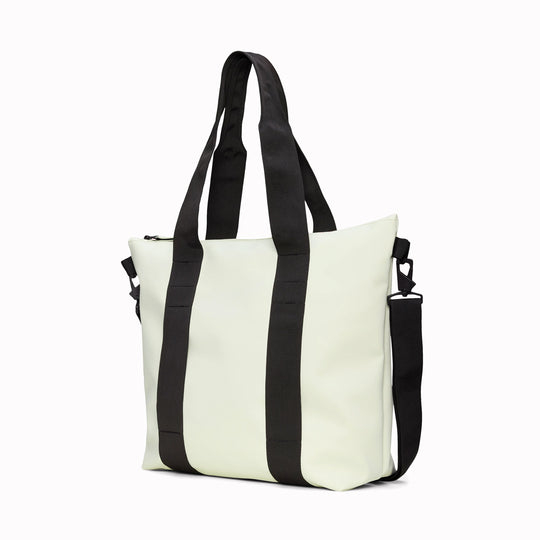 Angled - Rains' Tote Bag Mini W3 in new season fashion colour Daze is a waterproof tote bag and a great companion for shopping trips as well as commuting to the office.