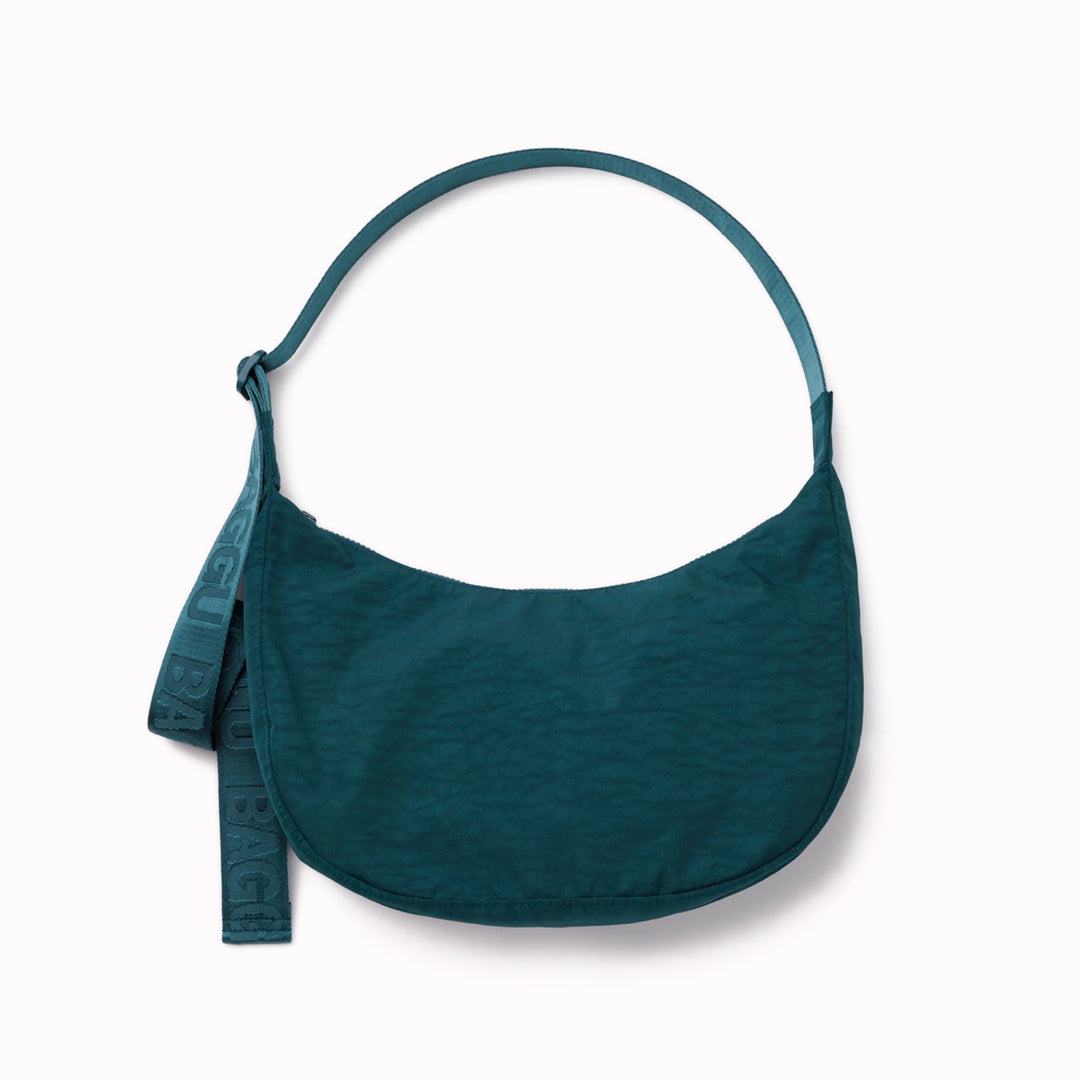 The Medium Crescent Bag in Deep Sea from Baggu is a stylish and versatile accessory that can complement any outfit.