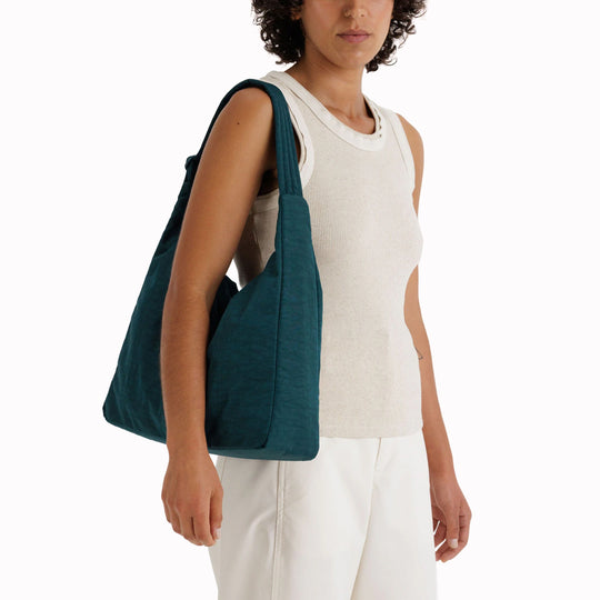 Practical shoulder bag designed for daily use and urban mobility. Crafted from recycled heavyweight nylon with a recycled ripstop lining