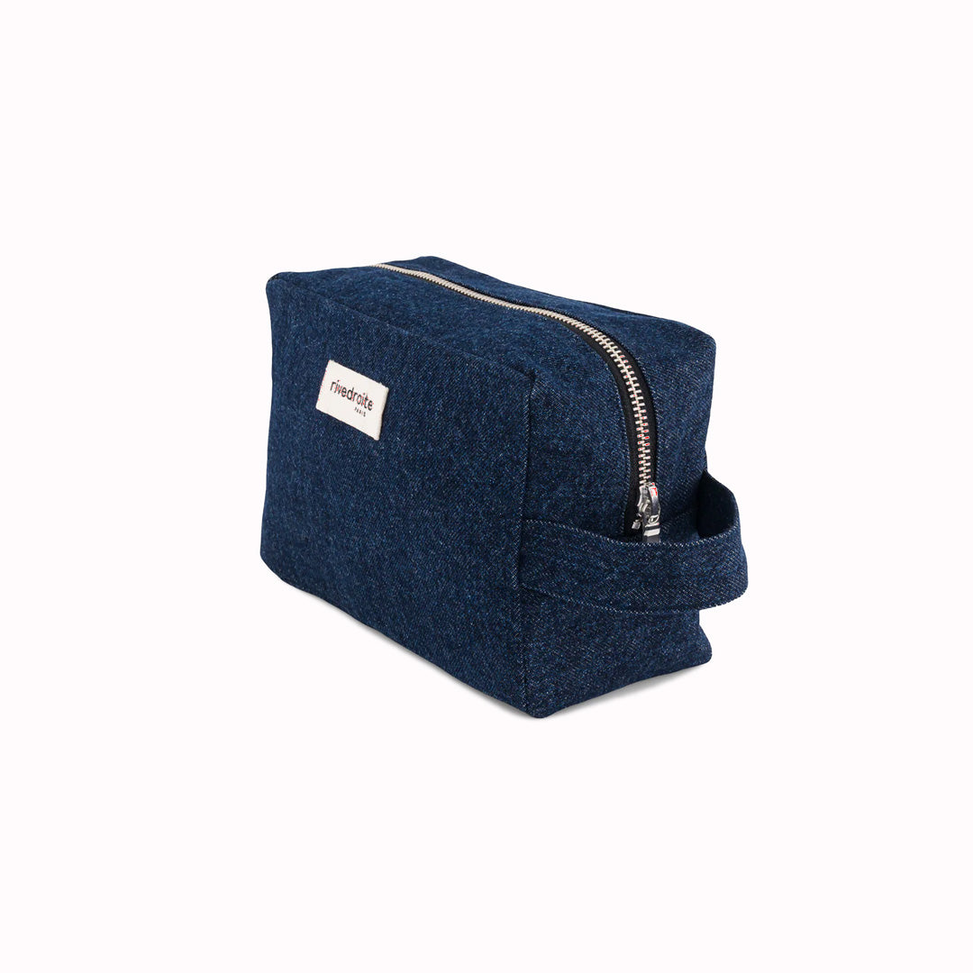 Denim Tournelles XL, A zippered pouch in a pleasing cube shape which is large enough for essential make up items on a weekend away.  Seen at an angle.