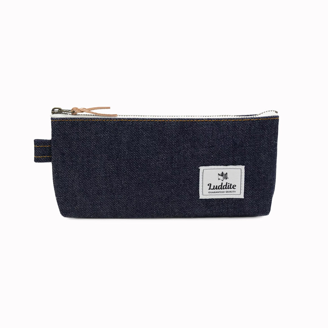 Flat pouch style pen and pencil case by Japanese stationery brand Luddite. the durable and tactile pencil case features a zipper along the length of the pencil case allows easy access to the items inside.