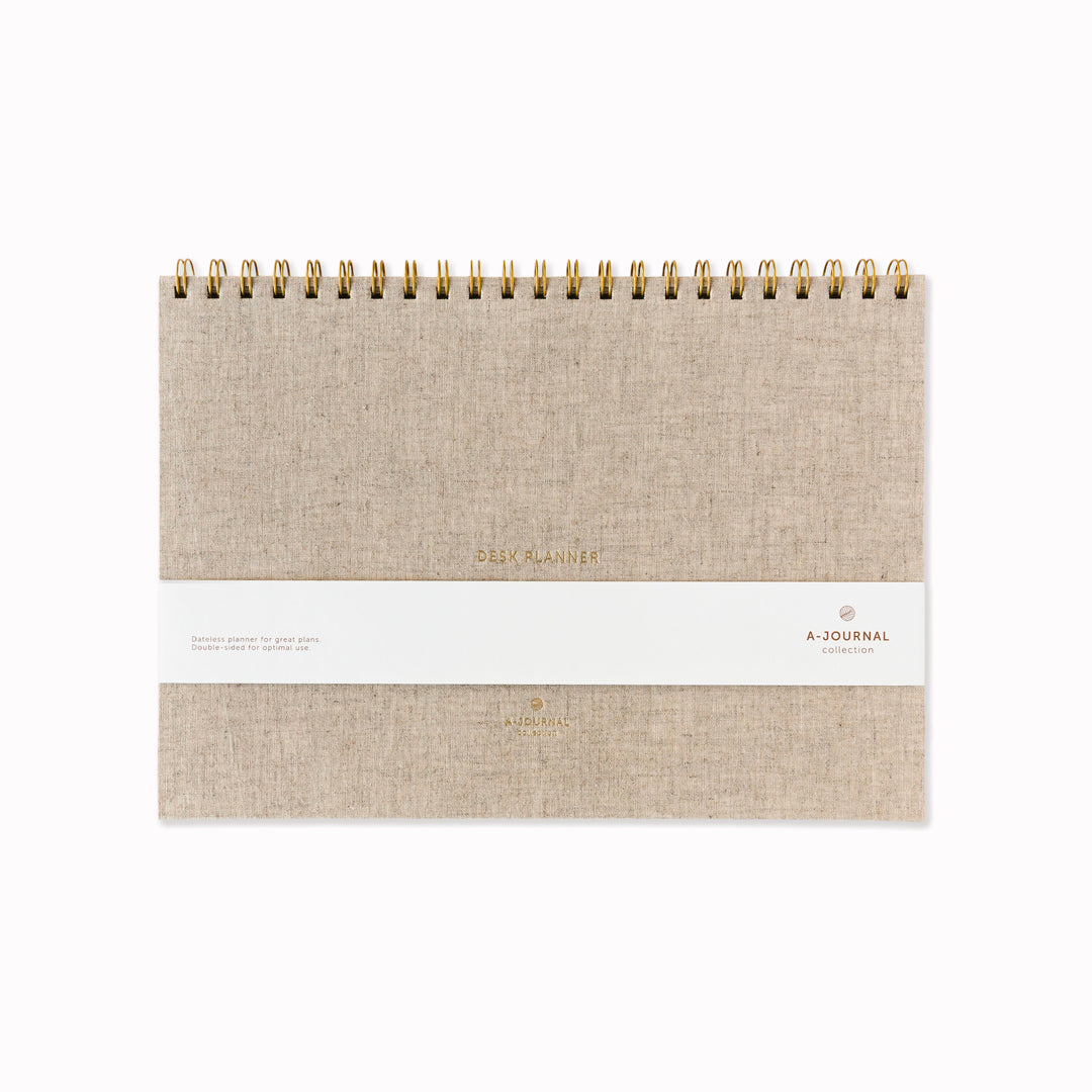 A desk planner built around a single weekly view, set in a structured A4-format page. The layout keeps everything visible at once — days, lists, and space to reset each week — without adding sections that compete for attention.