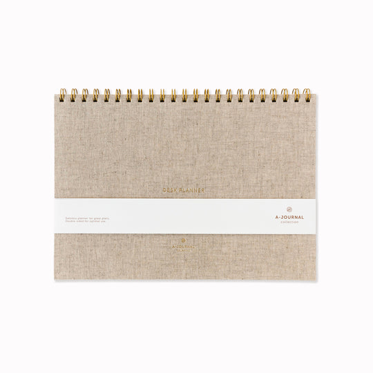 A desk planner built around a single weekly view, set in a structured A4-format page. The layout keeps everything visible at once — days, lists, and space to reset each week — without adding sections that compete for attention.