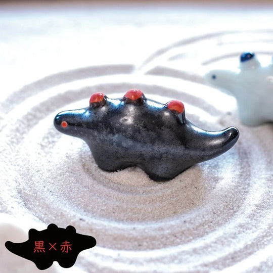Dinosaur shaped chopstick rest made from 'Minoyaki' porcelain, fired at a high temperature and hand finished in Gifu prefecture, Japan.