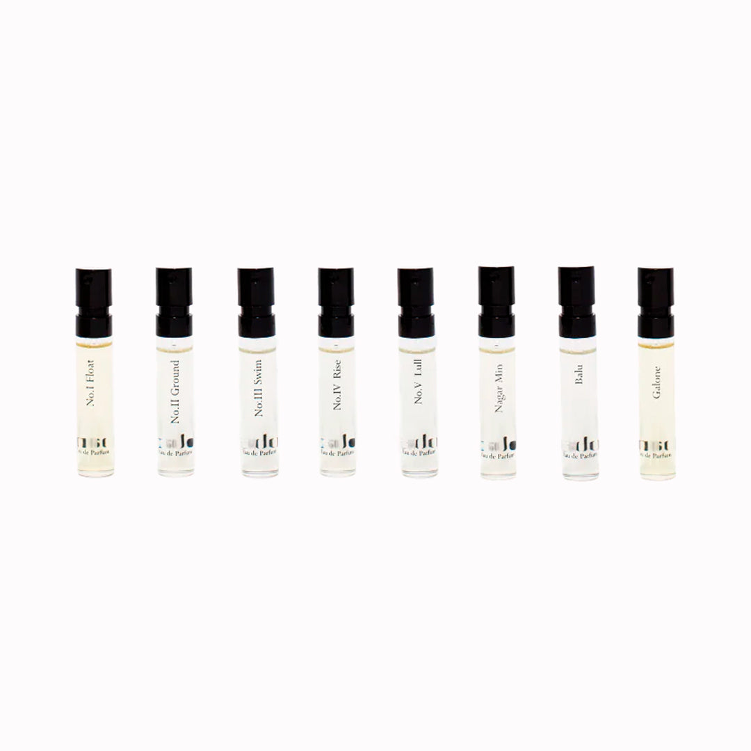 Row of small perfume bottles with black caps on a white background from Gabar Fragrance Discovery Set