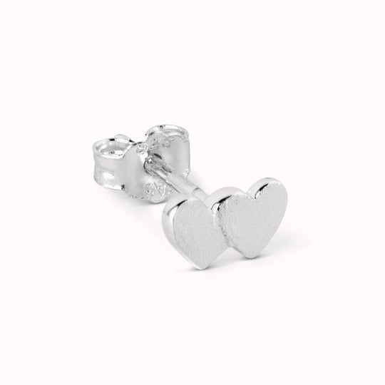 Domino Hearts 2, a pair of Sterling silver overlapping hearts, bursting with love. Like all of LULU Copenhagen's earrings it is sold individually and made to mix and match.