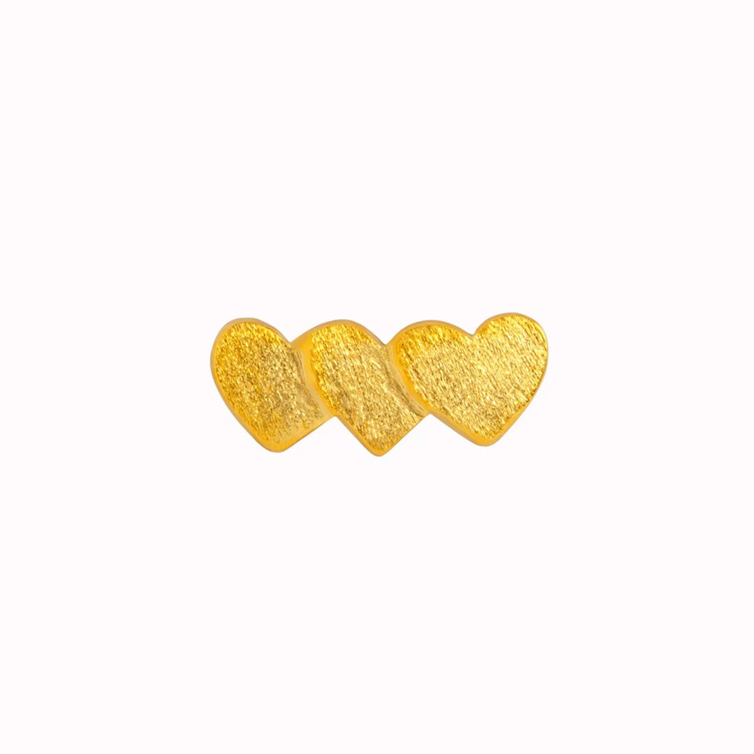 Domino Heart 3 is a trio of love hearts, stacked together to form a cute and playful single ear stud in a brushed gold plated finish. Wear alone or mix and match with other earrings from Lulu Copenhagen.