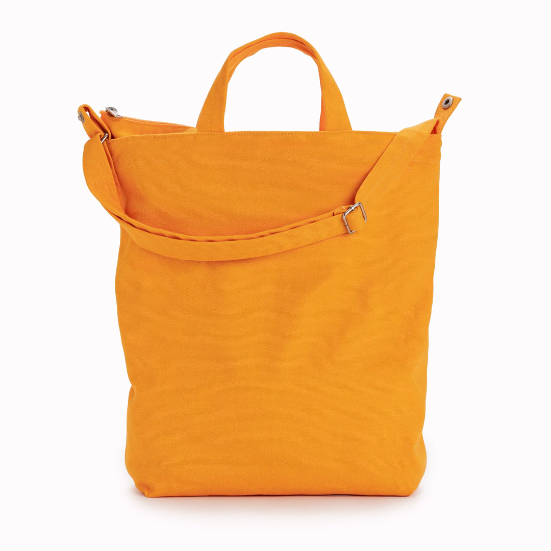 A bright and cheerful Tangerine Shopper - perfect everyday bag from Baggu for toting your laptop, yoga clothes, LPs or art supplies.