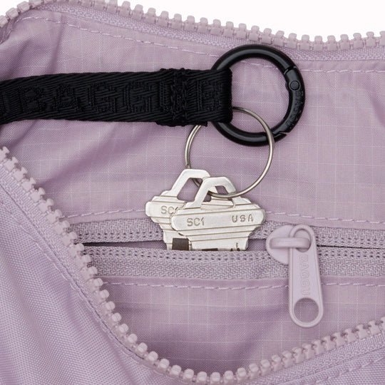 The Small Crescent Bag in Dusty Pink from Baggu is a stylish and versatile accessory that can complement any outfit. 