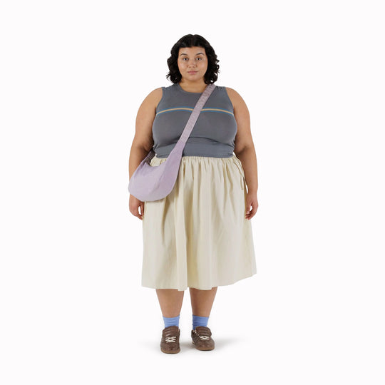 The Medium Crescent Bag in Dusty Pink from Baggu is a stylish and versatile accessory that can complement any outfit. It is made of durable nylon and features a zippered main compartment, an interior slip pocket, and an adjustable shoulder strap.