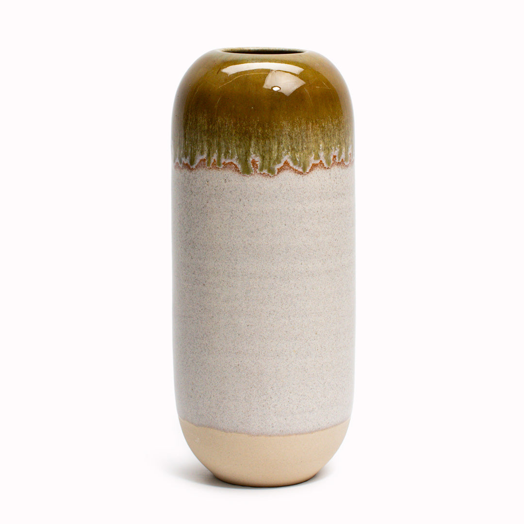 The brown hued Earth Sand design is hand-thrown in watertight stoneware. Due to the rounded taper at the top of the vase, the glaze melts down the sides of the cylindrical vase mimicking melting ice.