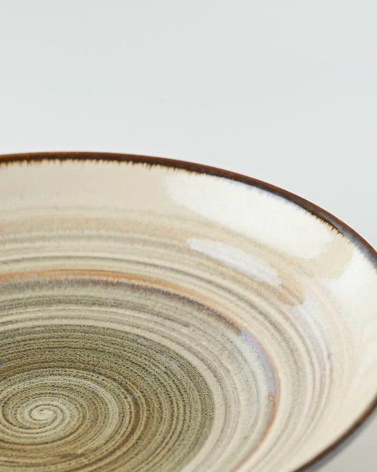 Shallow noodle bowl with irregular earthy toned swirl pattern on a cream glazed base. Diameter 23cm and height approx 5cm.