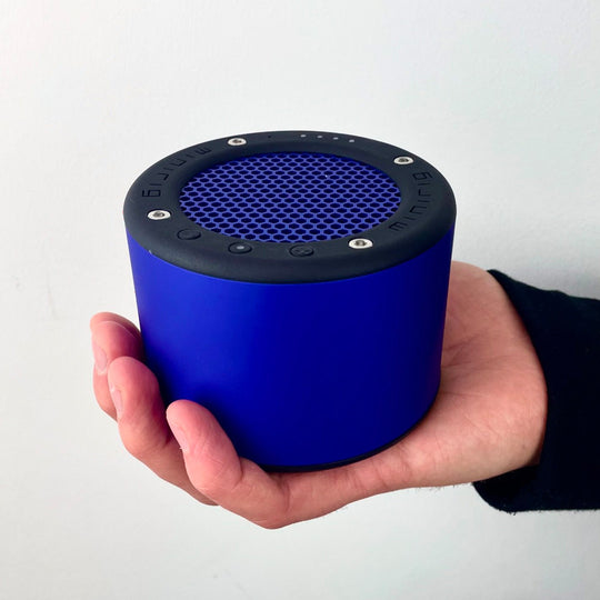 In Hand - The Minirig Mini 4 in Electric Blue is a portable Bluetooth speaker that represents the latest innovation in audio technology. Crafted in Bristol, UK, this speaker is the result of over a decade of design evolution, offering a robust anodized aluminium and high-impact ABS construction.